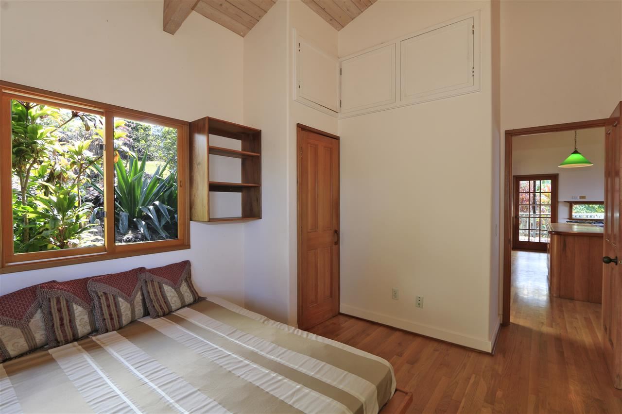 13434 Kula Highway Kula, HI 96790 - Photo 6 of 30 a bedroom with a bed and a large window with wooden floor