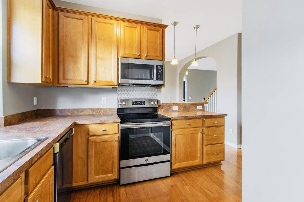 3609 Sugar Tree Place Durham, NC 27713 - Photo 5 of 22 a kitchen with stainless steel appliances granite countertop a stove a sink and a microwave