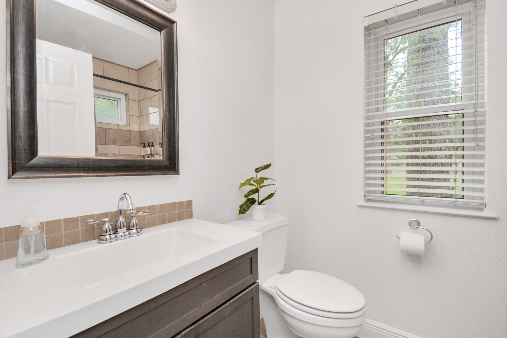 7830 Pardee Street Houston, TX 77028 - Photo 15 of 24 a bathroom with a sink a toilet and a window