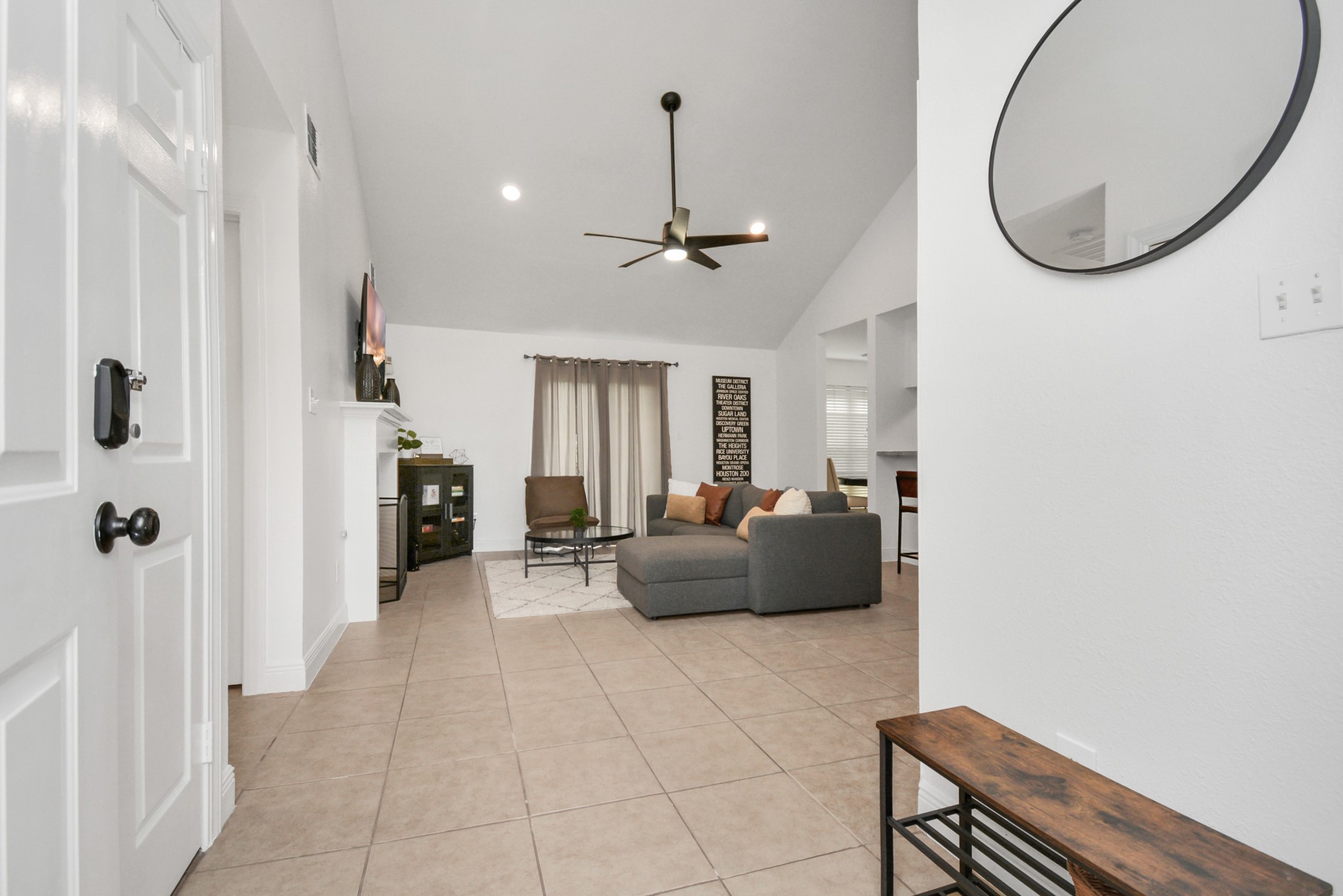 7830 Pardee Street Houston, TX 77028 - Photo 3 of 24 a living room with furniture a mirror and a chandelier