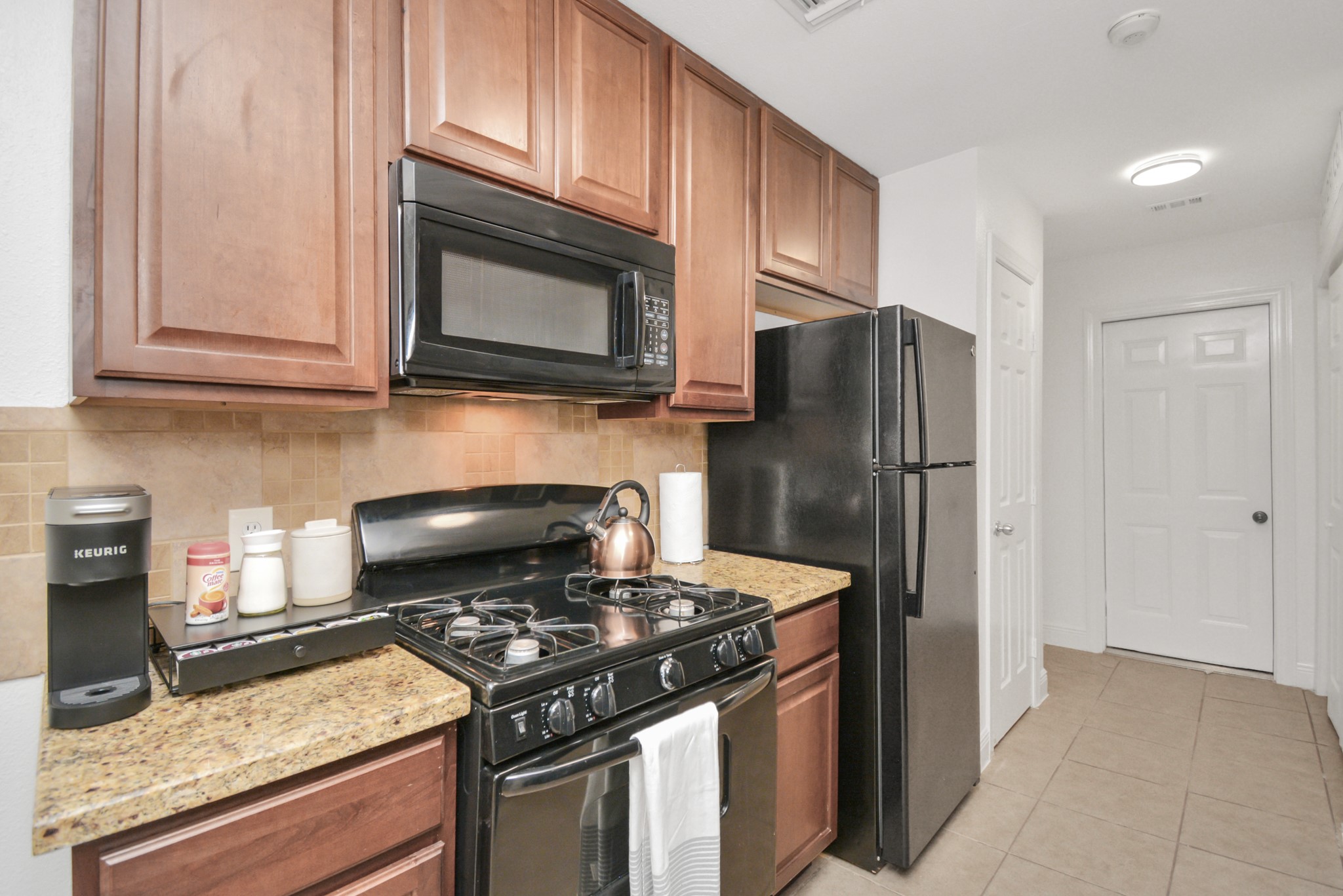 7830 Pardee Street Houston, TX 77028 - Photo 7 of 24 a kitchen with stainless steel appliances granite countertop a stove and a refrigerator
