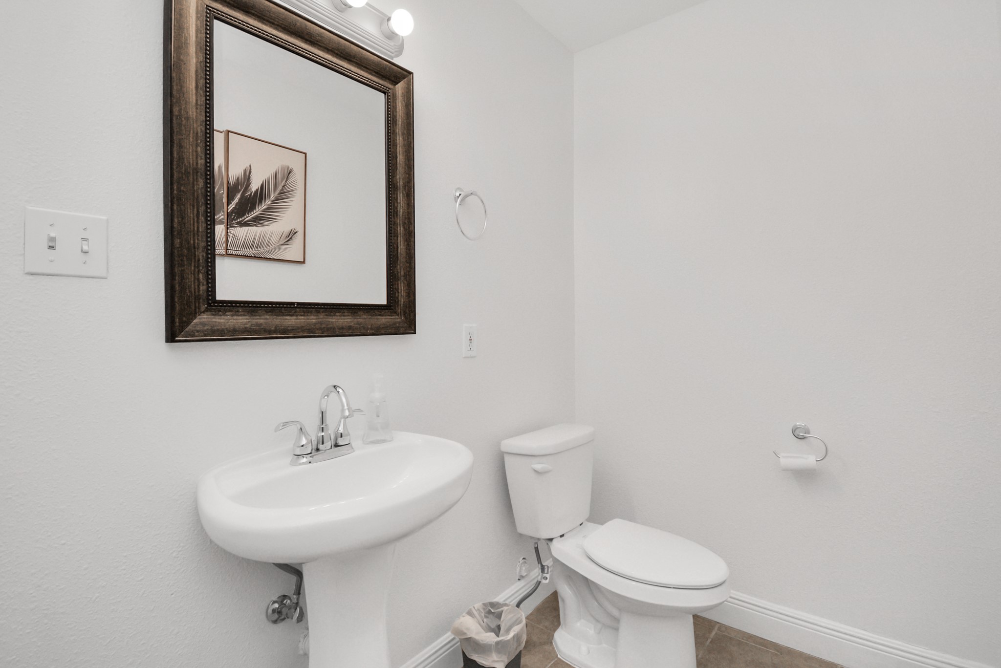 7830 Pardee Street Houston, TX 77028 - Photo 10 of 24 a bathroom with a toilet sink and mirror