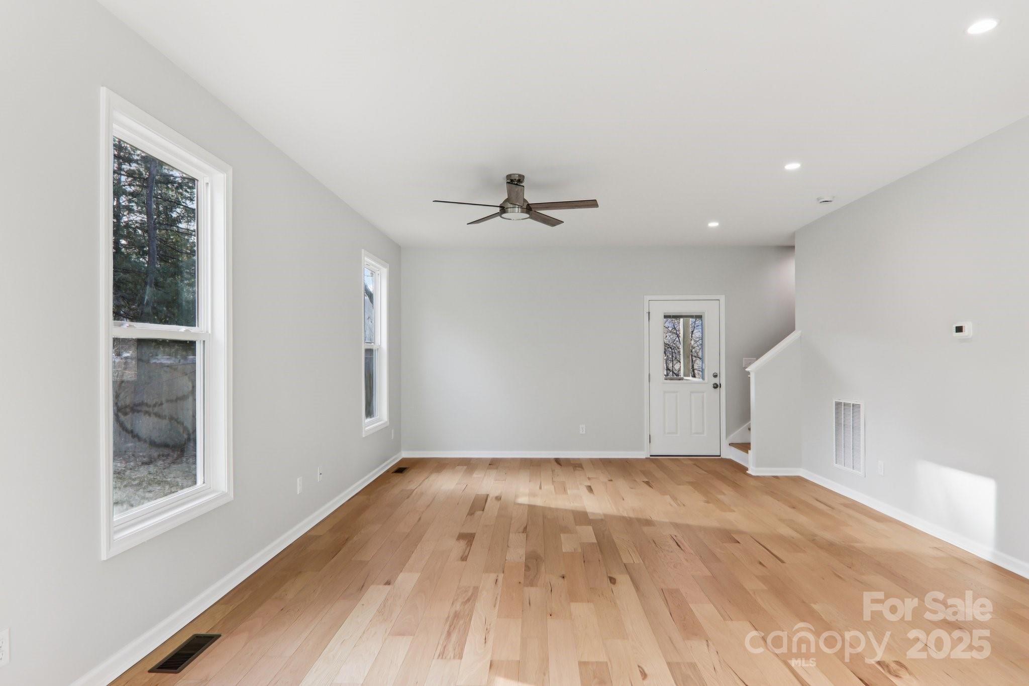 119 Lincoln Rdg Drive, Unit 1 Candler, NC 28715 - Photo 12 of 44 a view of a room with wooden floor and a ceiling fan