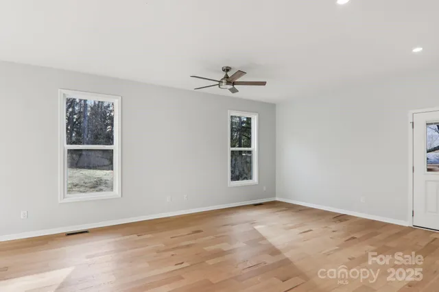 an empty room with windows and closet