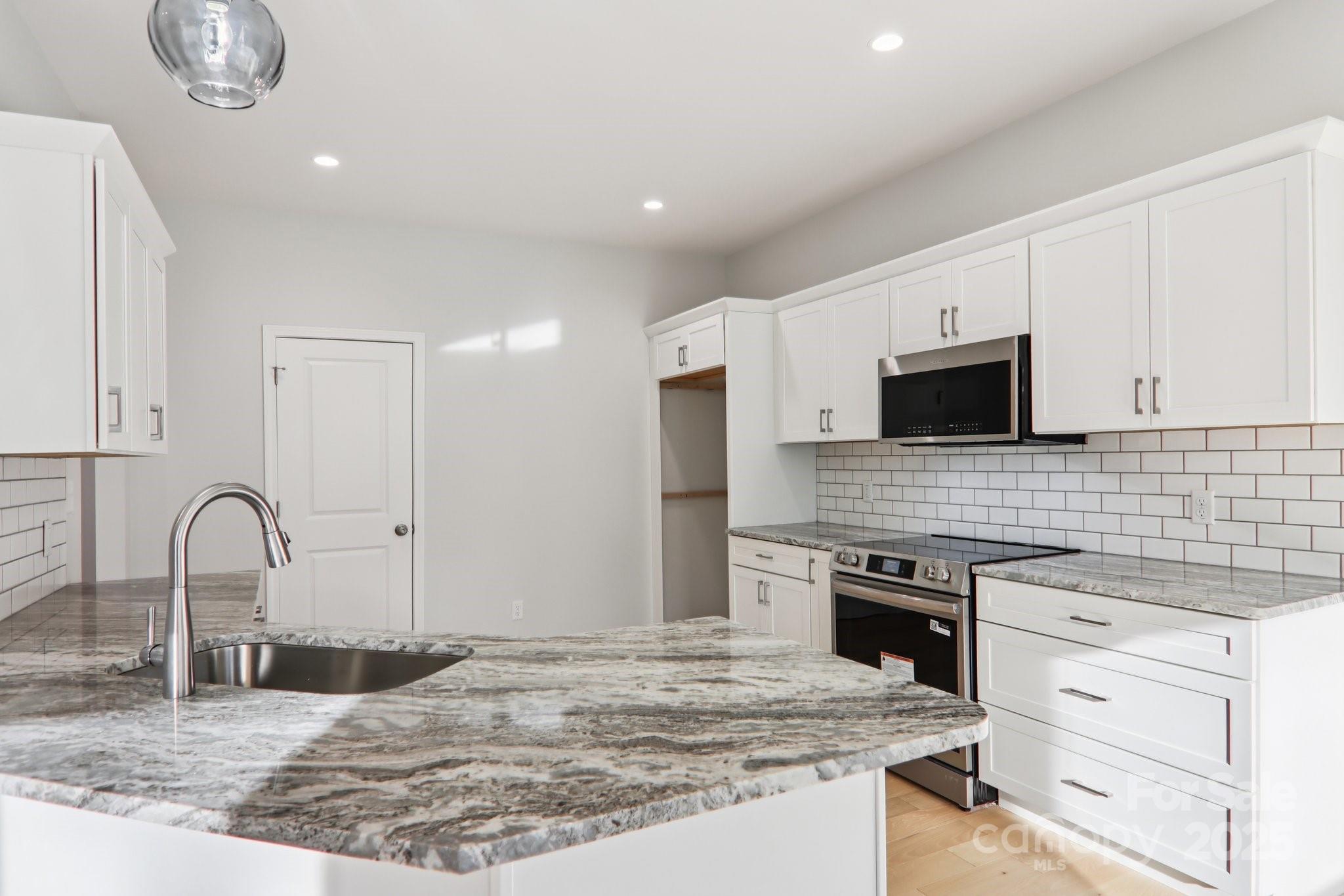 119 Lincoln Rdg Drive, Unit 1 Candler, NC 28715 - Photo 16 of 44 a kitchen with stainless steel appliances granite countertop a stove top oven a sink and dishwasher