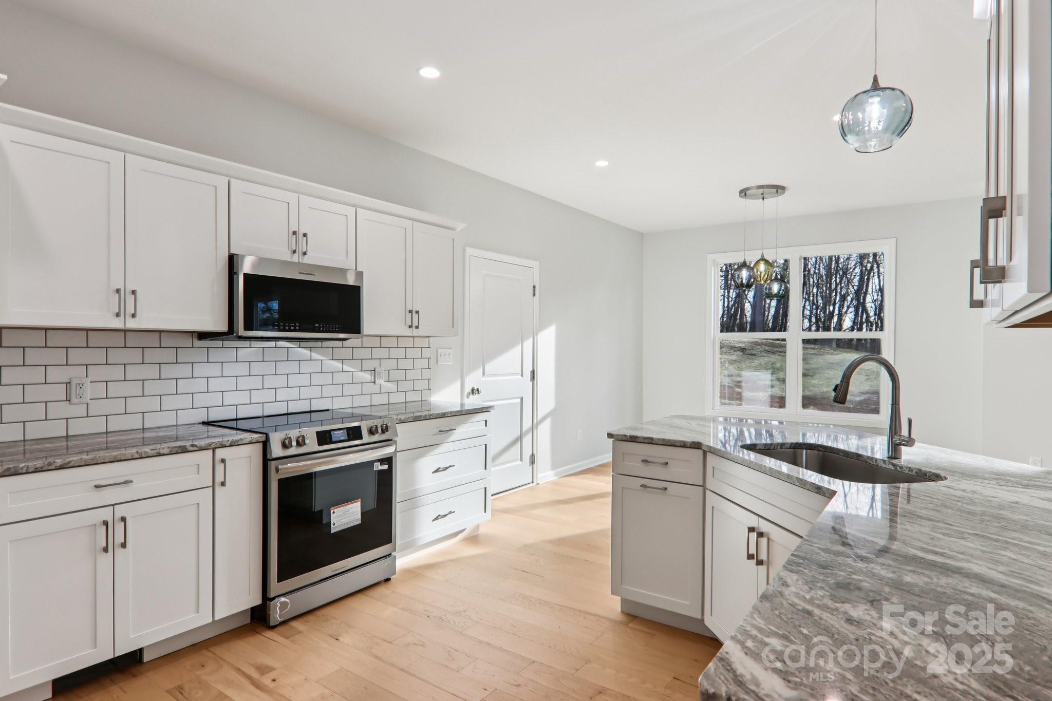 119 Lincoln Rdg Drive, Unit 1 Candler, NC 28715 - Photo 17 of 44 a kitchen with stainless steel appliances granite countertop a stove and a sink