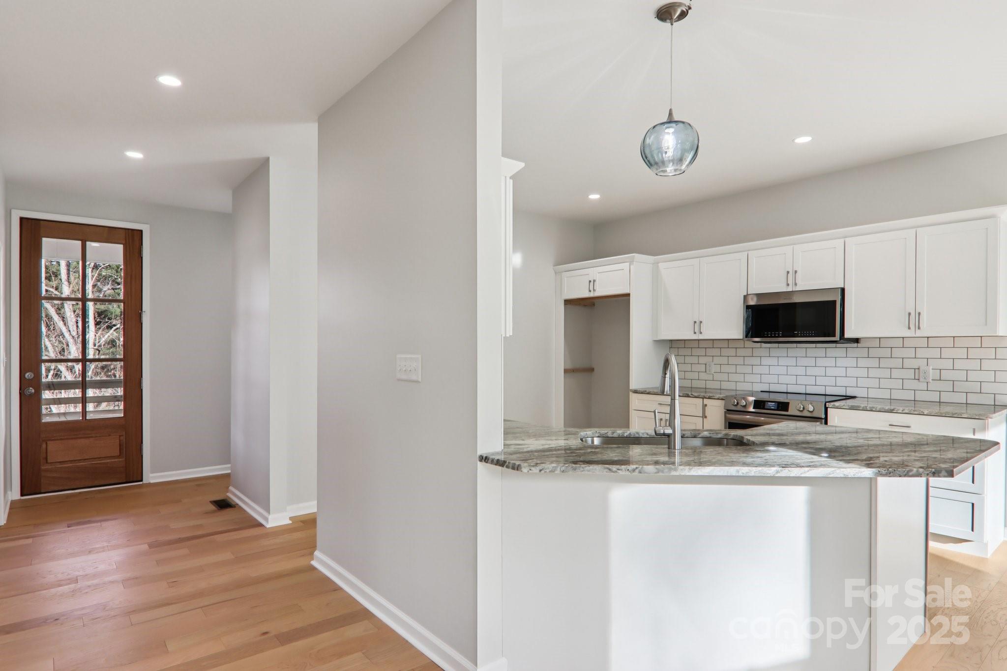 119 Lincoln Rdg Drive, Unit 1 Candler, NC 28715 - Photo 21 of 44 a kitchen with stainless steel appliances granite countertop a sink and a stove top oven