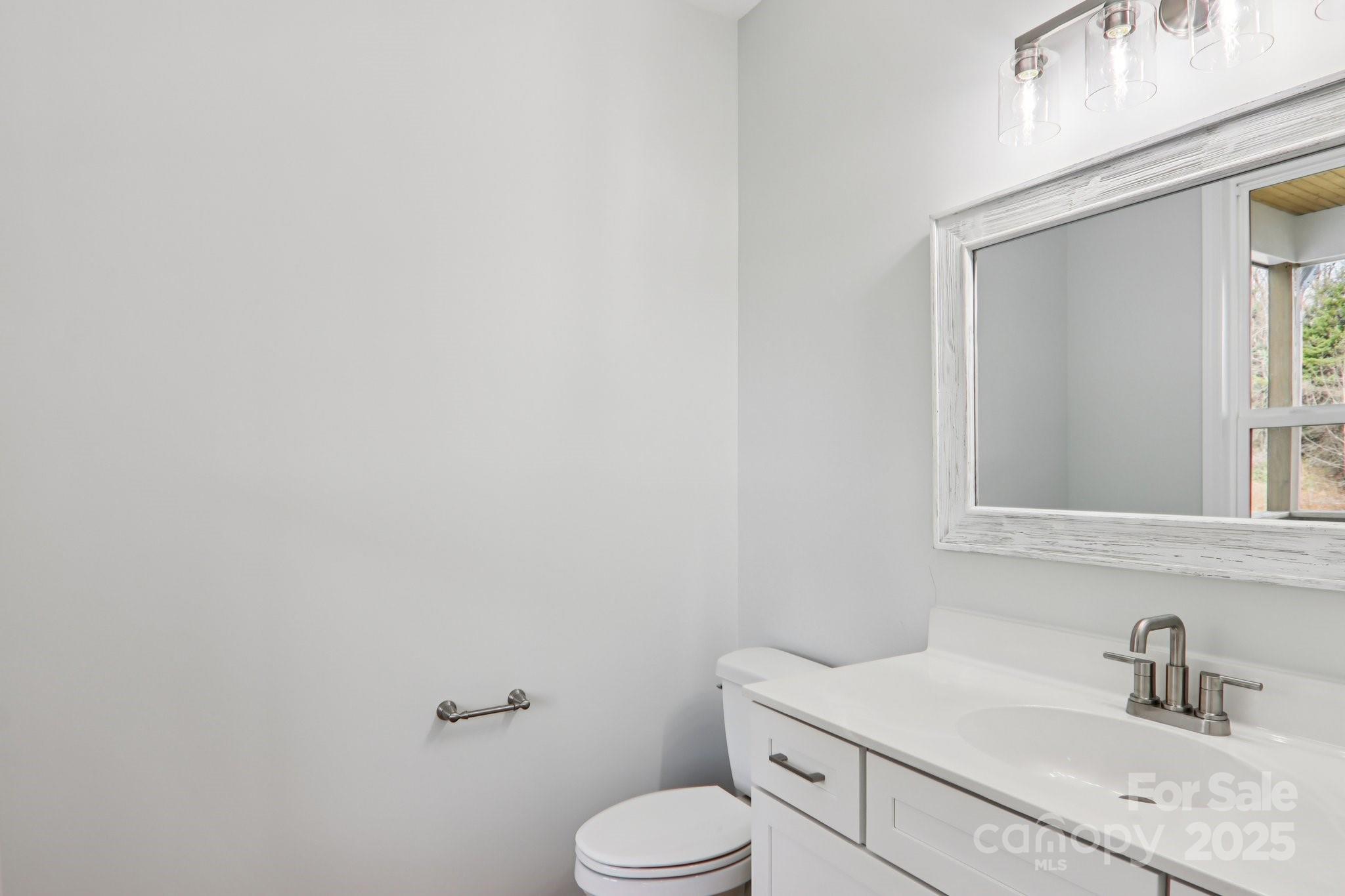 119 Lincoln Rdg Drive, Unit 1 Candler, NC 28715 - Photo 24 of 44 a bathroom with a sink toilet and vanity
