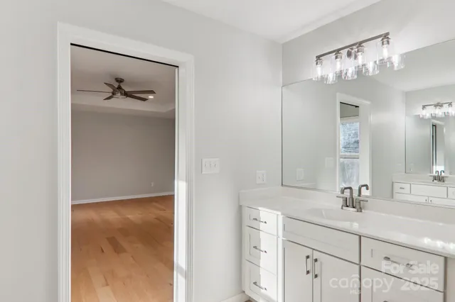 a bathroom with a shower sink and mirror