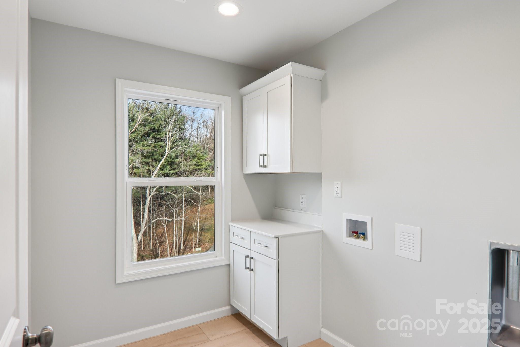 119 Lincoln Rdg Drive, Unit 1 Candler, NC 28715 - Photo 36 of 44 a kitchen with white cabinets and window