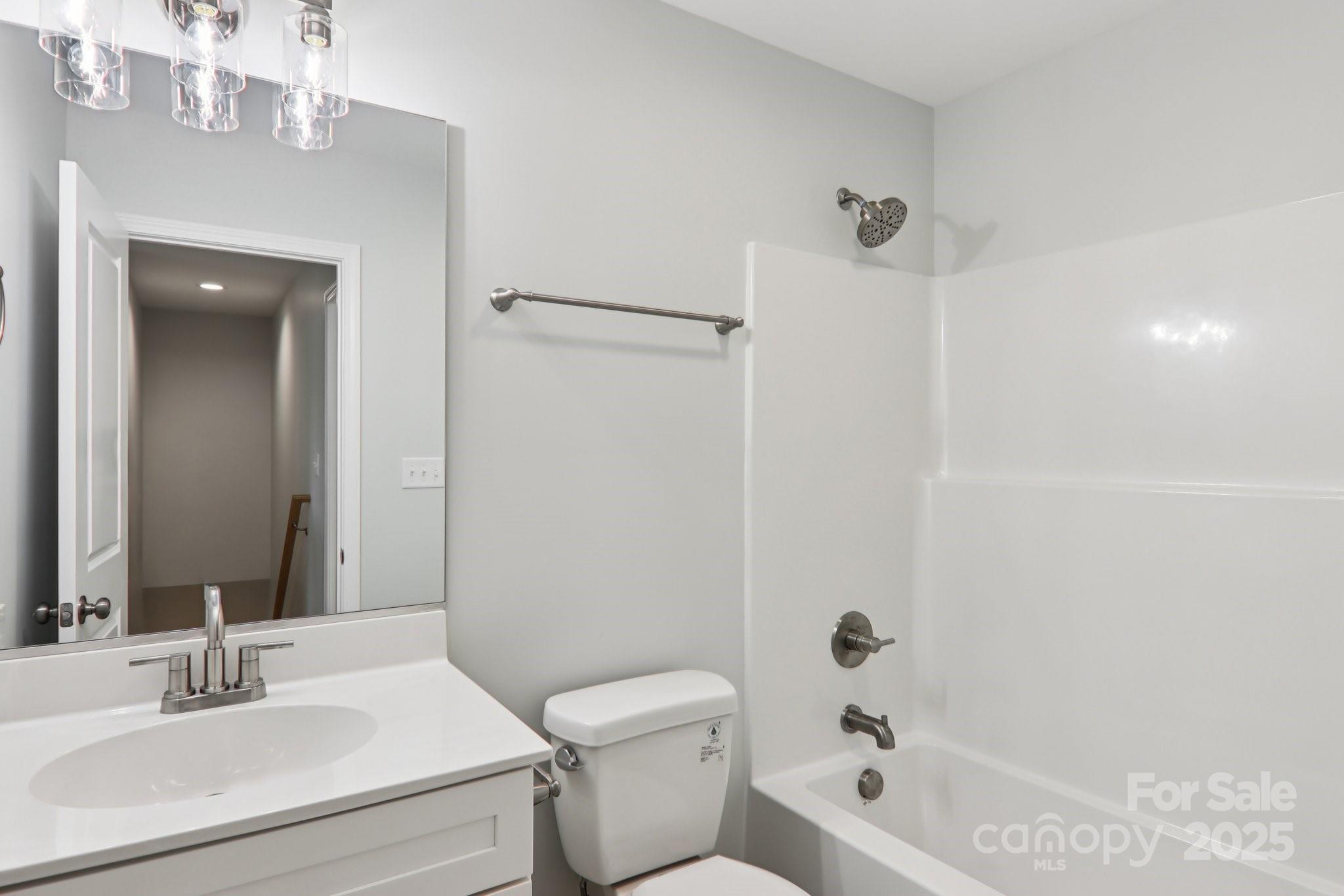 119 Lincoln Rdg Drive, Unit 1 Candler, NC 28715 - Photo 39 of 44 a bathroom with a bathtub shower sink vanity and toilet