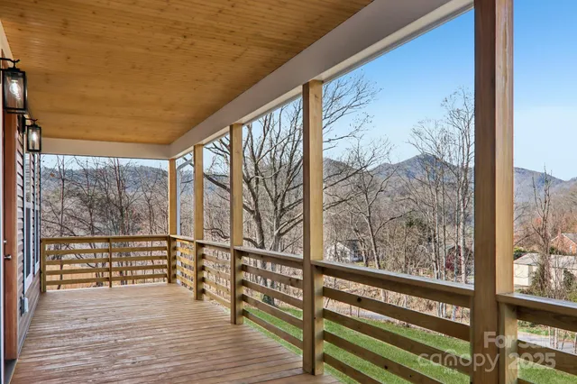 a view of hallway with wooden floor