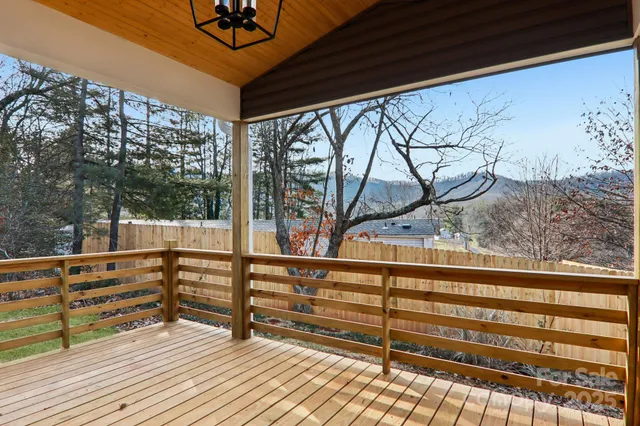 a view of a balcony with couches and wooden floor