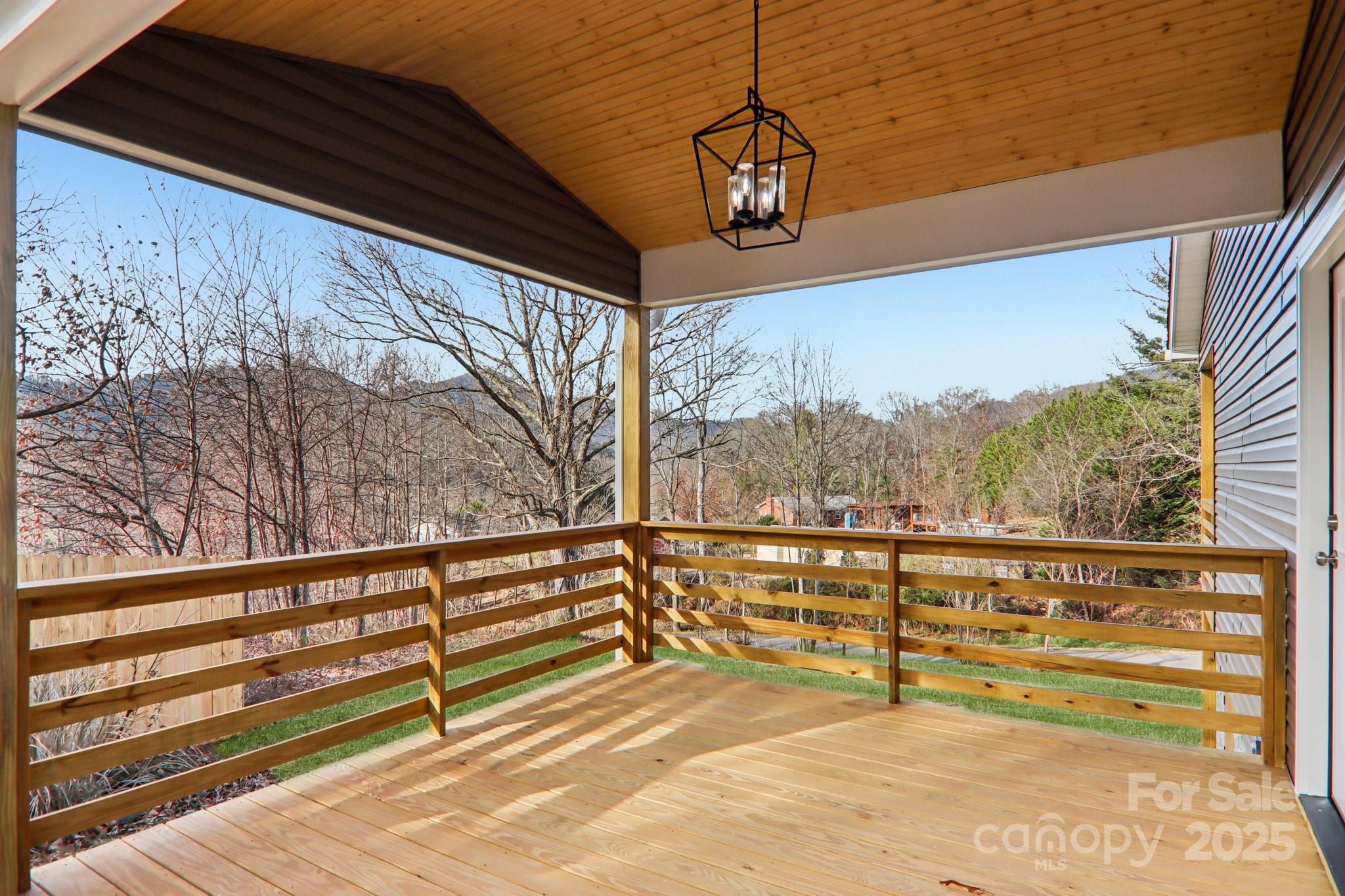119 Lincoln Rdg Drive, Unit 1 Candler, NC 28715 - Photo 42 of 44 a view of a balcony with couches and wooden floor