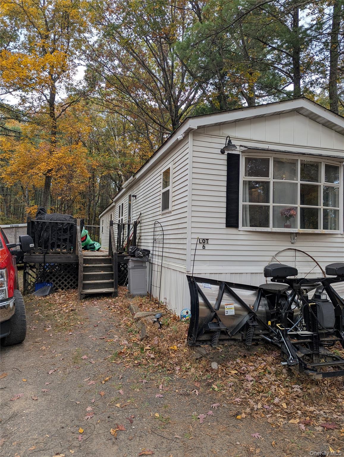 a backyard of a house with barbeque oven table and chairs