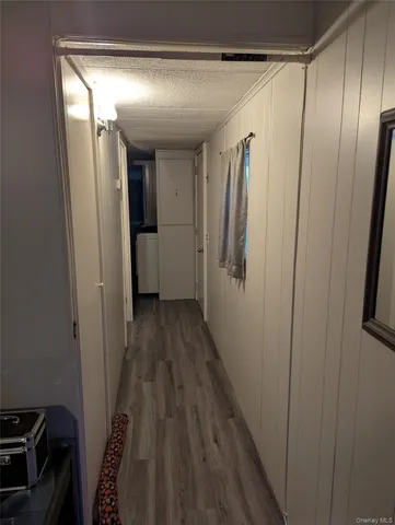 a view of hallway with wooden floor