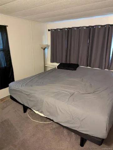 a bed sitting in a bedroom next to a window