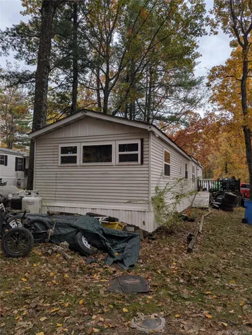 a backyard of a house with barbeque oven and outdoor seating