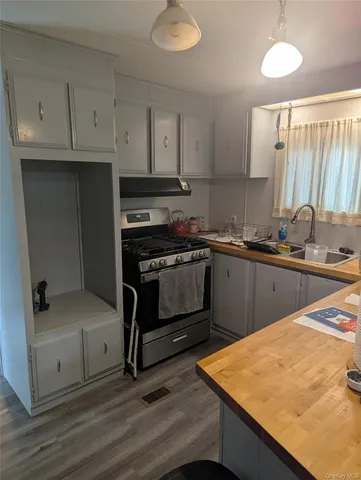 a kitchen with a sink appliances and cabinets