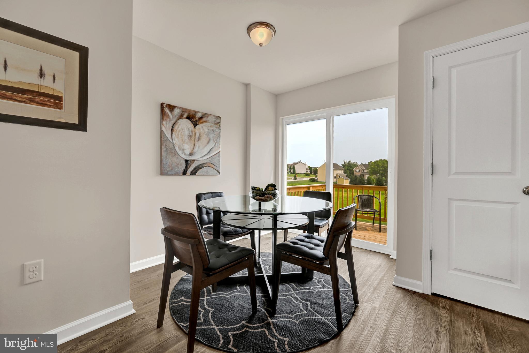 22 Landing Place, Unit 22 York, PA 17408 - Photo 8 of 27 a view of a dining room with furniture window and wooden floor