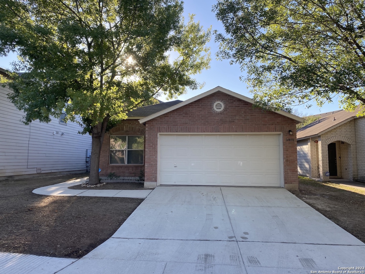a view of a house with a tree