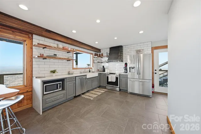 a kitchen with stainless steel appliances a stove a sink and a refrigerator