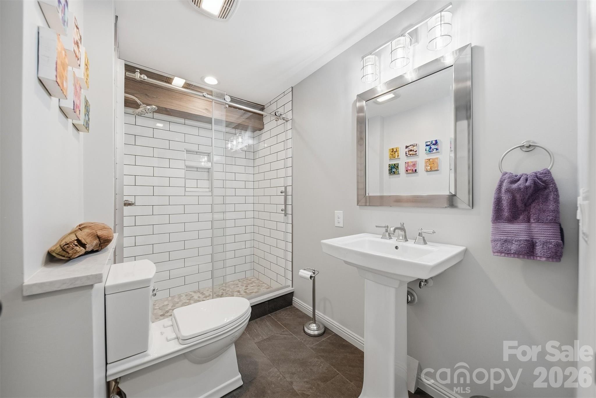 6500 Burkemont Road Morganton, NC 28655 - Photo 25 of 48 a bathroom with a toilet sink and mirror