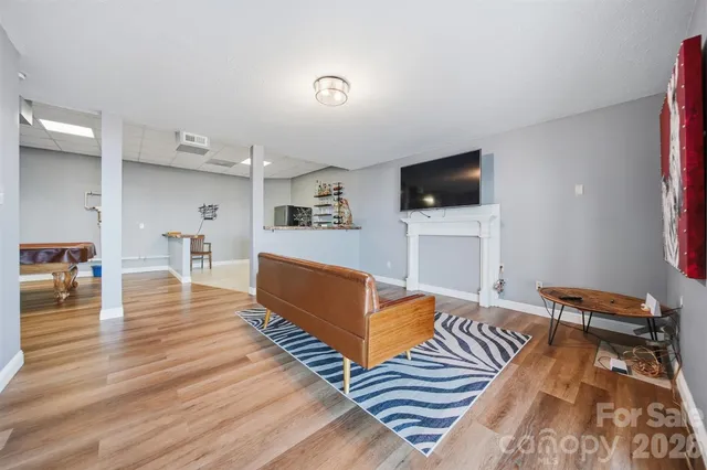 a room with wooden floors and pool table
