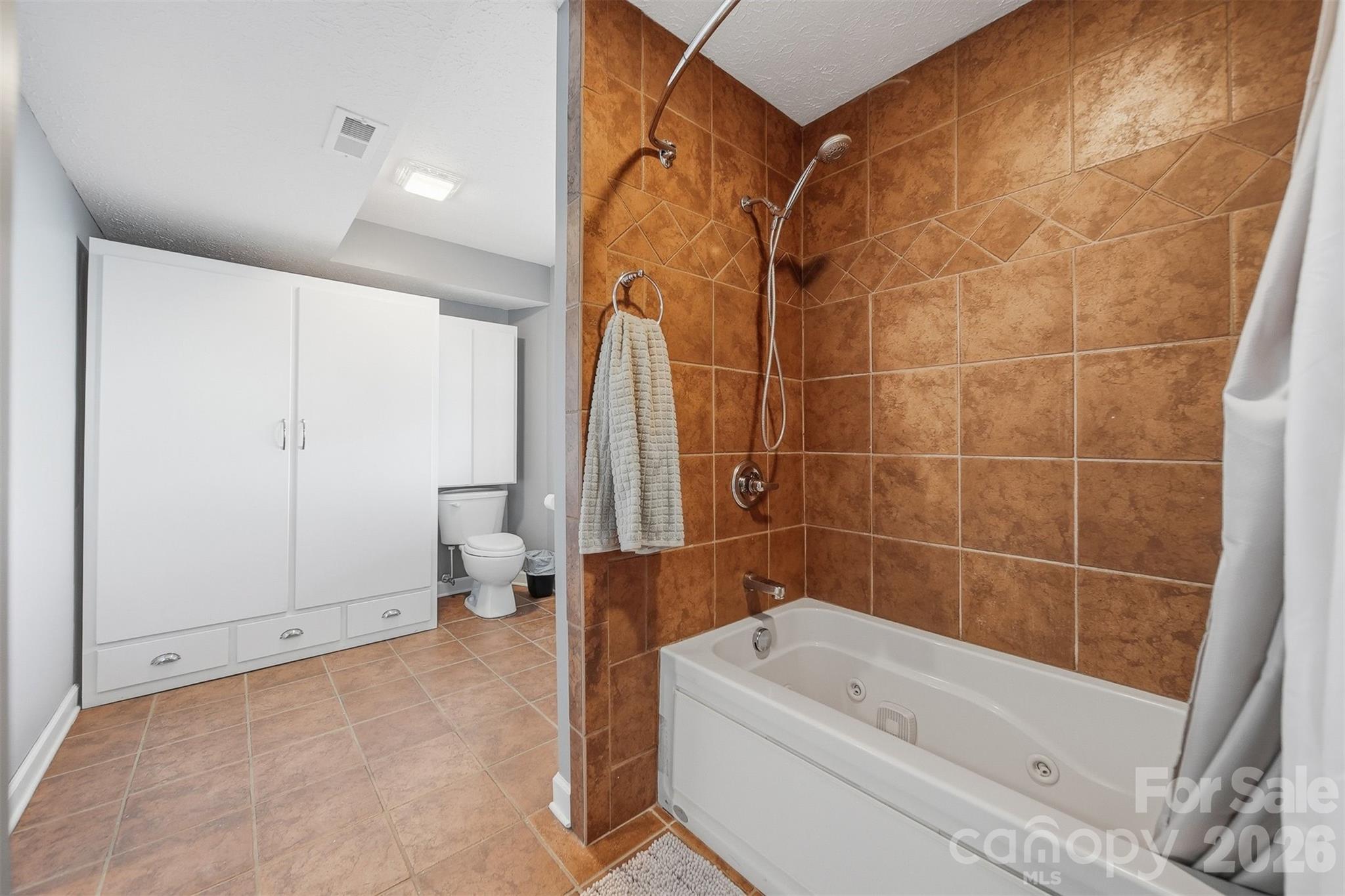 6500 Burkemont Road Morganton, NC 28655 - Photo 34 of 48 a bathroom with a tub a toilet and a shower