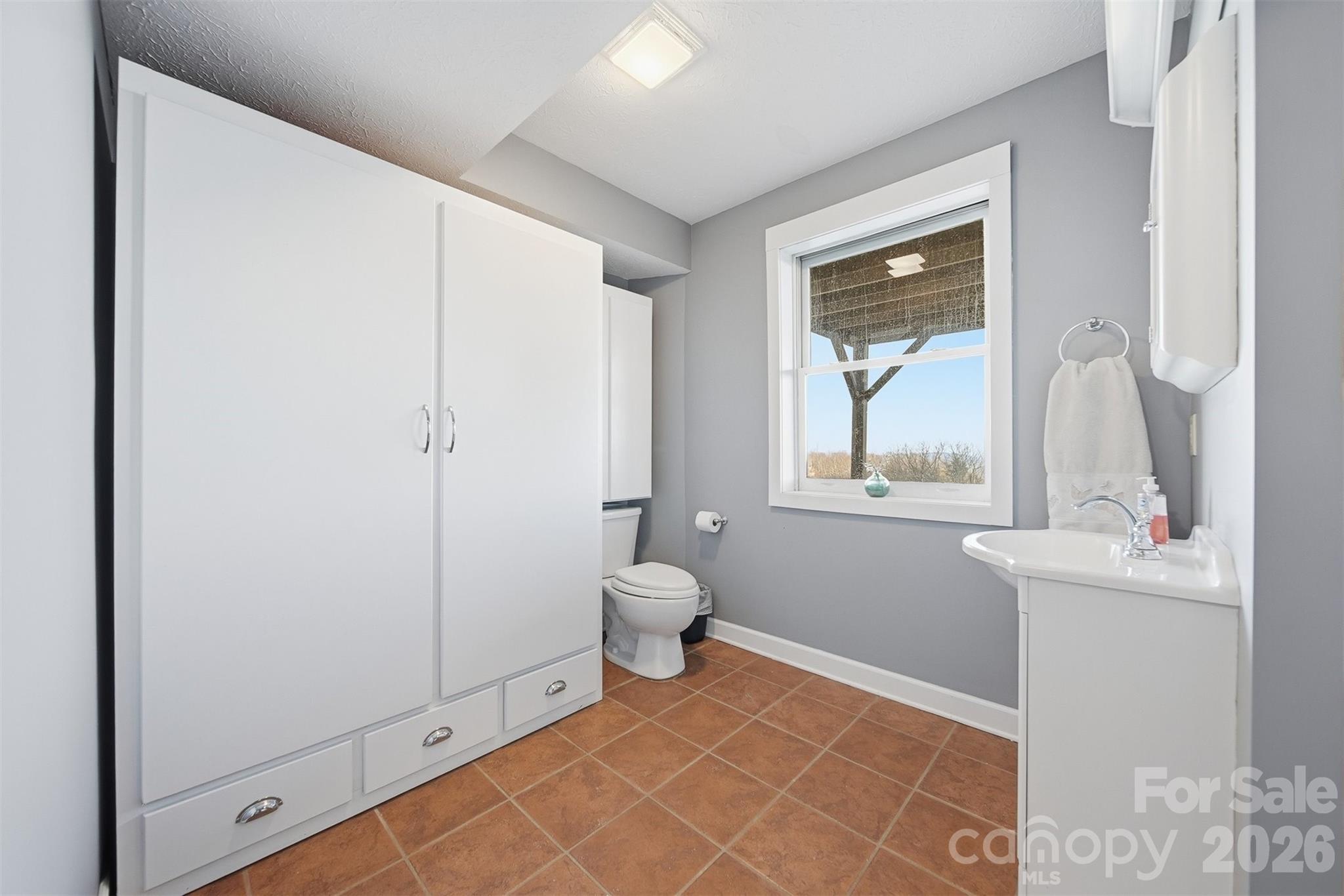 6500 Burkemont Road Morganton, NC 28655 - Photo 35 of 48 a bathroom with a toilet sink and mirror