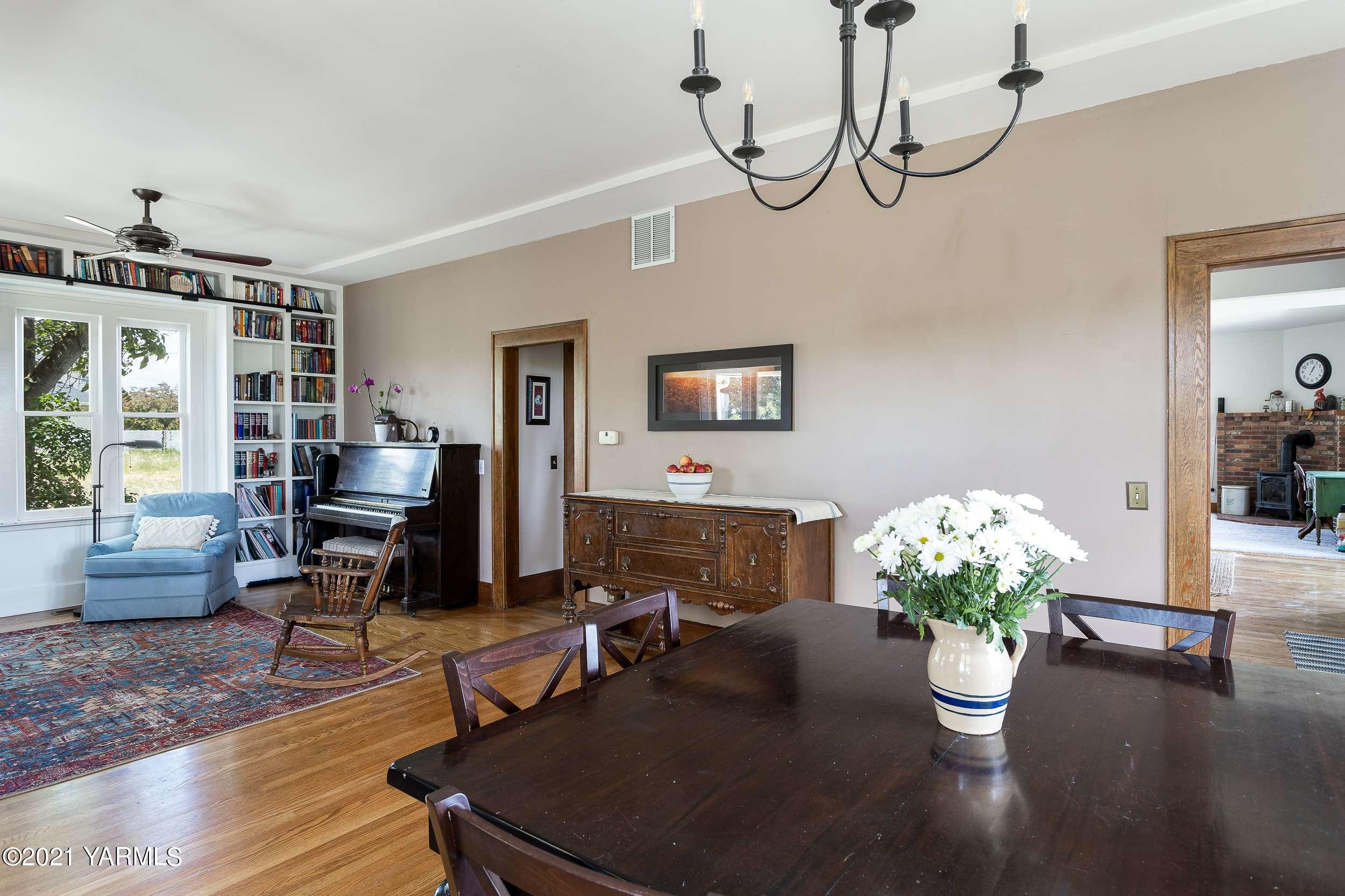 11805 Occidental Road Yakima, WA 98908 - Photo 22 of 51 a dining room with furniture potted plants and wooden floor