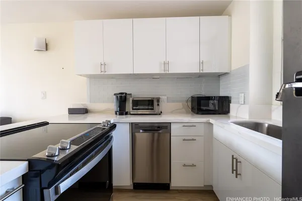 a kitchen with a refrigerator sink and stove
