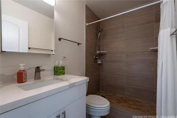 a kitchen with granite countertop a sink cabinets and stainless steel appliances