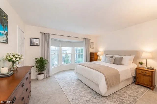 a bedroom with a large bed and potted plant