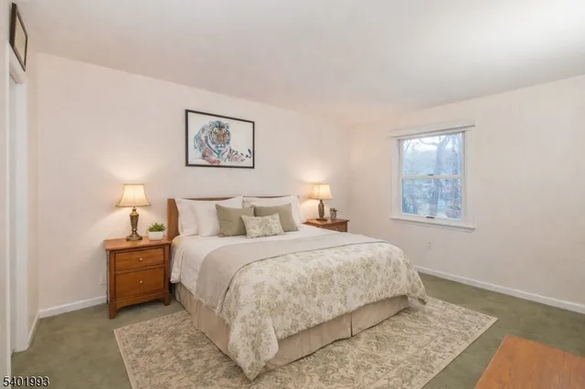 a bedroom with a bed and a night stand