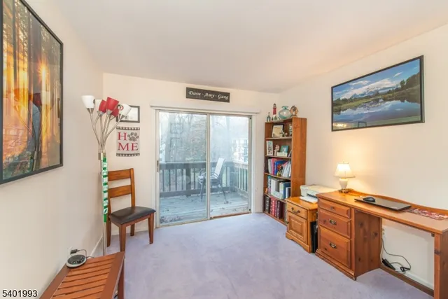 a living room with furniture and a book shelf