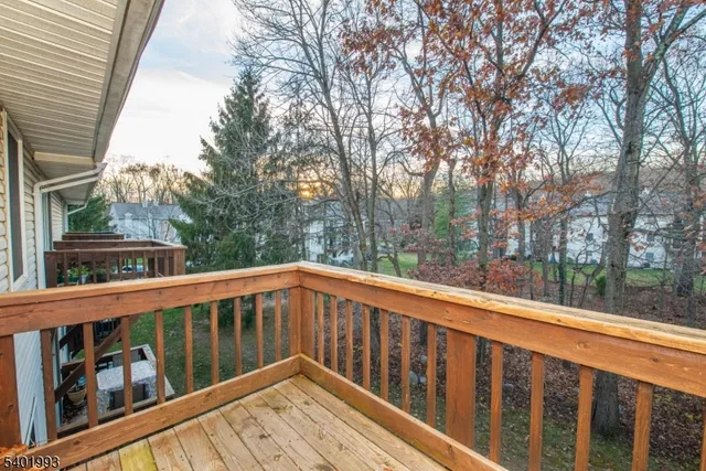 a view of roof deck with wooden fence and floor
