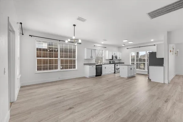 a view of kitchen with wooden floor and windows