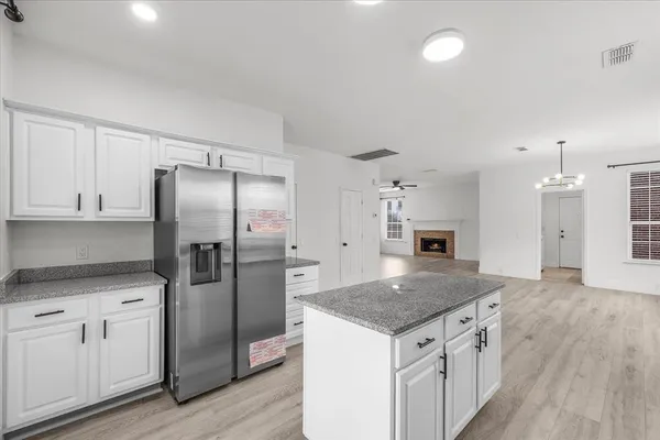 a kitchen with a center island and stainless steel appliances