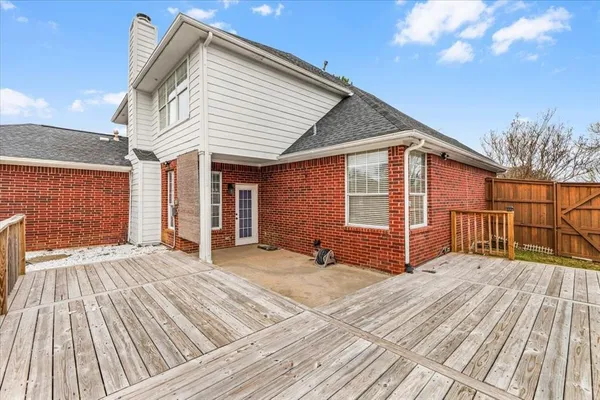 a view of backyard with a deck and wooden floor