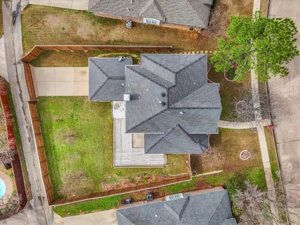 an aerial view of a house with a yard