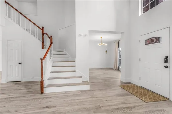 a view of entryway and hall with wooden floor