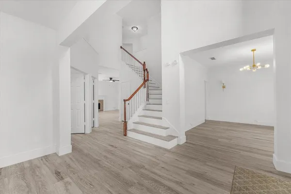 a view of entryway and hall with wooden floor
