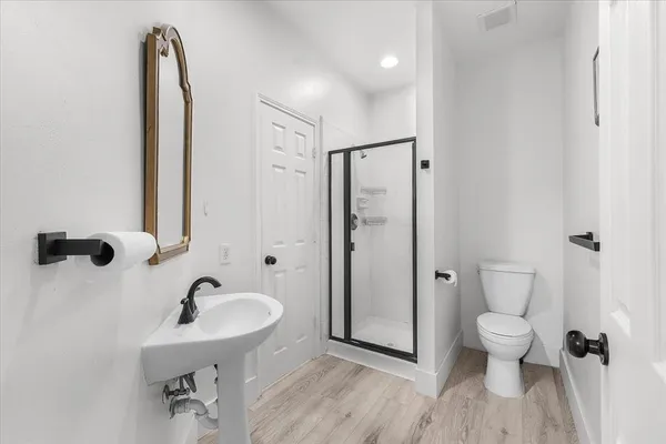 a bathroom with a sink toilet and shower