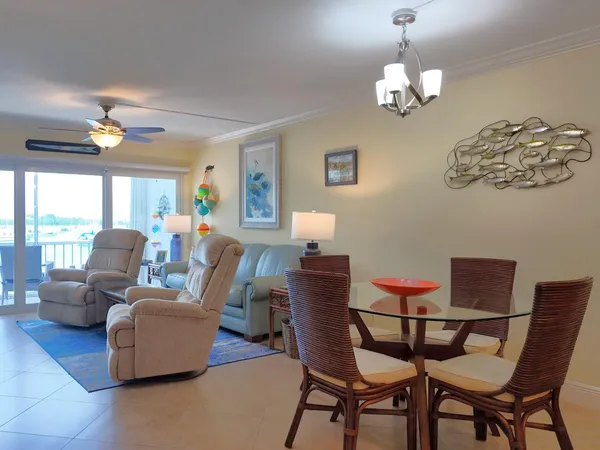 a living room with furniture a lamp and a chandelier