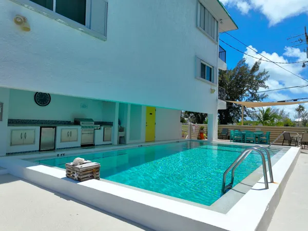 a view of deck with table and chairs and wooden floor