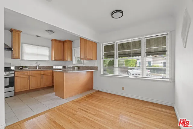 a kitchen with a cabinets a sink and appliances