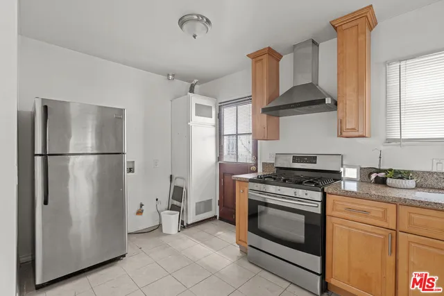 a kitchen with stainless steel appliances a stove a refrigerator and a sink