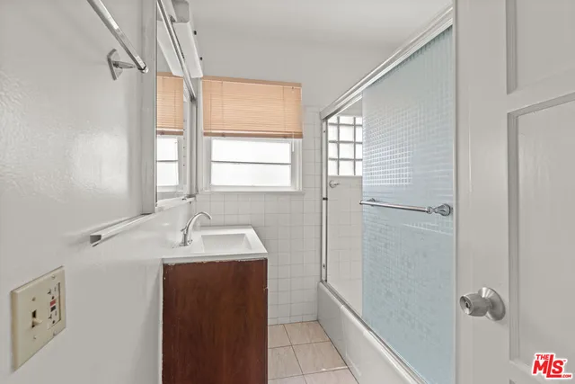 a bathroom with a sink and shower
