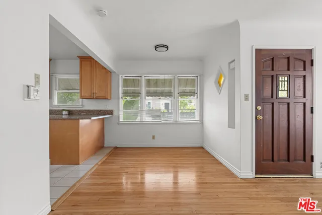 a view of a kitchen with wooden floor and a kitchen space